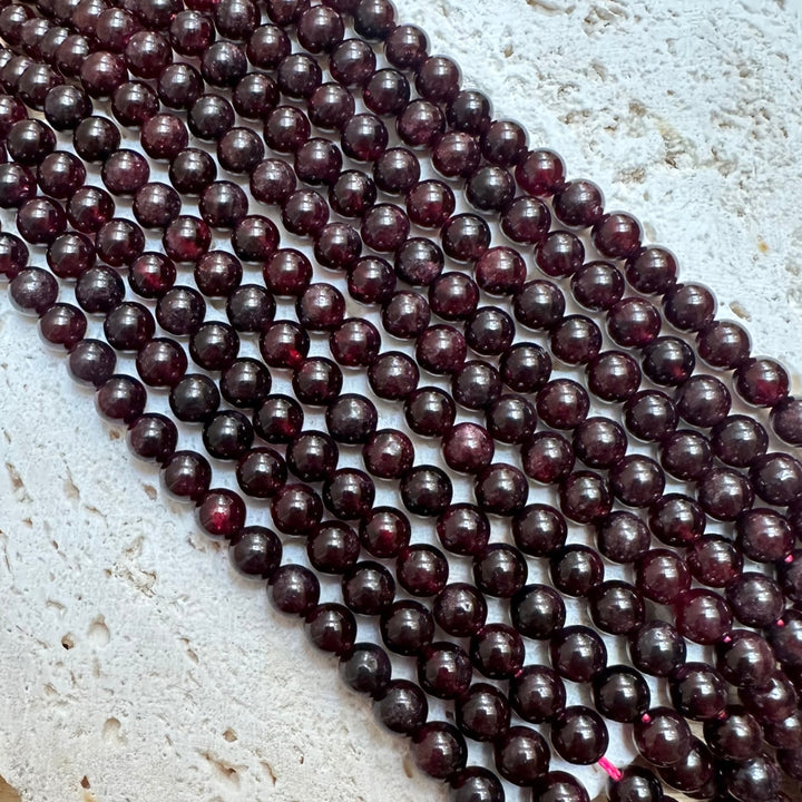 6mm round garnet beads, glossy, 1 strand, 16 inches, approx. 65 beads.