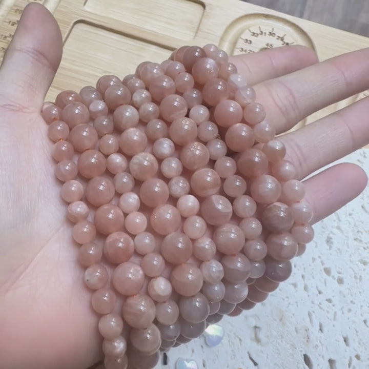 6mm round peach moonstone beads, glossy, 1 strand, 16 inches, approx. 65 beads.